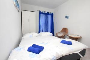 BogomoljeにあるRobinson Editaのベッドルーム1室(青いタオル付きのベッド1台付)