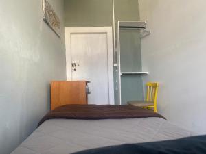 a bedroom with a bed and a chair and a door at Casa Augusta 2 in Braga