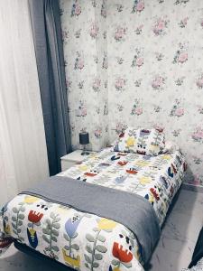 1 dormitorio con 1 cama y papel pintado con motivos florales en Apartamento KENOA metropolitano, en Madrid
