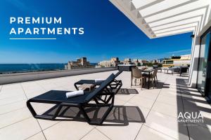 a patio with chairs and tables on a roof at Aqua Apartments Bellamar, Marbella in Marbella