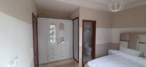 a bedroom with a bed and a large mirror at MediSweet Apartments Meublés in Yaoundé