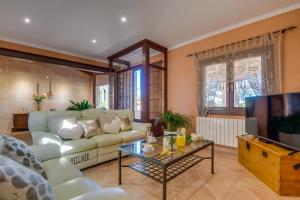 a living room with a couch and a tv at Ideal Property Mallorca - Can Ribas in Can Picafort