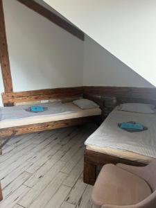 a room with two beds and a chair in it at Penzión Pri Mlyne in Nitra