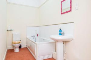 a white bathroom with a sink and a toilet at Private Parking Central With Roof Terrace in Wolverhampton