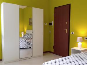 a bedroom with a mirror next to a bed at Casa Salera in Lonato del Garda