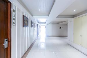 an empty hallway of a building with a hallway at A Room Bangkok Sathorn in Bangkok