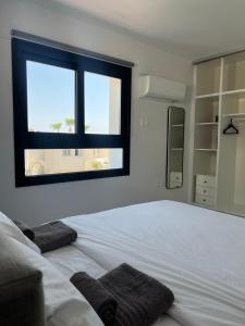 een slaapkamer met een groot wit bed en een raam bij Sea La Vie #2 - Luxury Seaview apartment in Paphos City