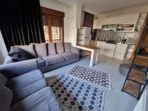 a living room with a couch and a table at Maltepe, Cevizli cozy apt in Istanbul