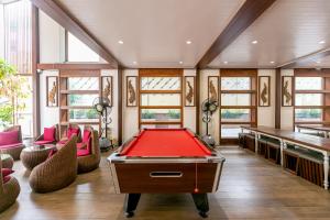 a billiard room with a pool table and two tables at A Room Bangkok Sathorn in Bangkok