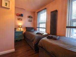 a bedroom with two beds and a window at Comfortable Margate Home in Margate