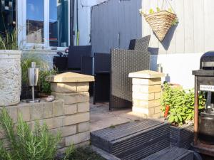 a patio with chairs and a bench in a yard at Comfortable Margate Home in Margate