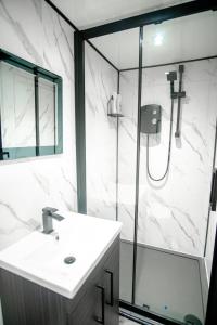 a bathroom with a sink and a glass shower at The Bunkhouse in South Shields +17 photos