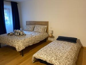 a bedroom with two beds and a window at ORVIETO ANTICA Apartment in Orvieto