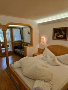 a bedroom with a bed with a large mirror at Residence Ciastel in Ortisei