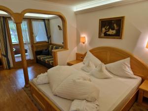 a bedroom with a bed with white pillows at Residence Ciastel in Ortisei