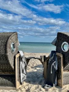 a pair of chairs on the beach at Landhaus Lütjenhof in Großenbrode