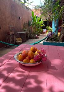 a plate of fruit on a red table at La Casa del Mango in Pampatar