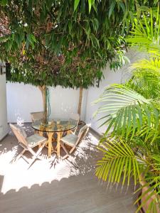 uma mesa e cadeiras e uma mesa e árvores em Nosotros Luxury Villa em Los Cristianos