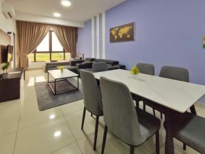 a room with a table and chairs and a couch at Bali Residence Melaka by Jzstay 2BR in Melaka
