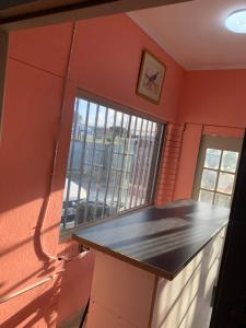 an empty room with a counter and a window at A house , Akan trust in Cape Town