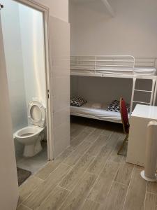 a small room with a toilet and a bunk bed at Ciel de Paris in Paris