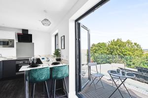 a kitchen with a large glass door leading to a patio at Redland Green Apartments by MyCityHaven in Bristol