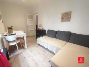 a bedroom with a bed and a table and a desk at Casas da Biquinha in Sintra