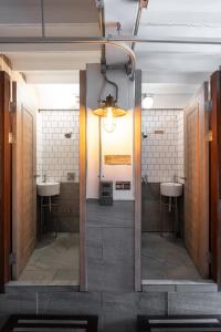 a bathroom with two sinks and two toilets at Bed Addict Hostel in Chiang Mai