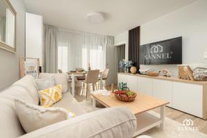 a living room with a white couch and a table at Apartament Elegance - Pobierowo Baltic Apartments in Pobierowo