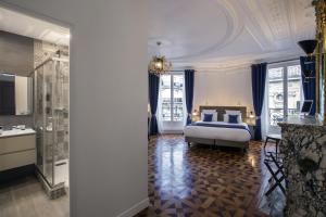 a bedroom with a bed and a bathroom at Vestay George V in Paris