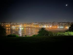 a view of a beach at night with a city at Coogee Sunrise in Sydney