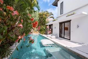 a swimming pool in the backyard of a house at Villa Plumeria - Walk to Bingin Beach in Uluwatu