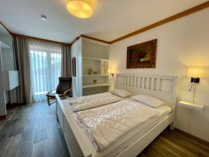 a bedroom with a large white bed in a room at Ferienwohnung Almblick in Reit im Winkl