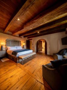 a large bedroom with a bed and a couch at Château de Belet in Saint-Aquilin