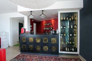 a bar with a bunch of bottles of wine at Hôtel Restaurant La Montagne De Brancion in Martailly-lès-Brancion