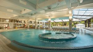 a large swimming pool in a large building at Hotel Terme Jezercica in Donja Stubica