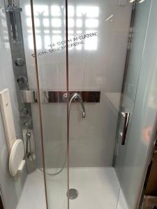 a shower with a glass door in a bathroom at Chalet Flobelle in Entremont