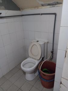 a bathroom with a toilet and a bucket at Sky Chalet at Axis Next To LRT Pandan Indah Ampang in Ampang
