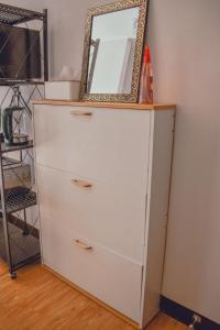a white dresser with a mirror on top of it at AiPad Condo Rentals in Davao City
