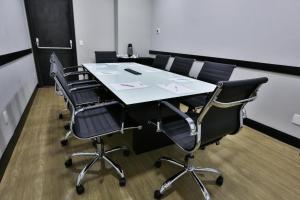 a conference room with a table and four chairs at King room - Brooklin flat in Sao Paulo