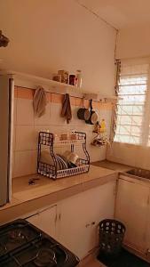a kitchen with a drying rack on the counter at Mombasa , Kenya Studio Apartment in Mombasa