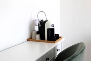 a desk with a coffee machine on a shelf at Villa Forte Salvi - Rooms in Peschiera del Garda +17 photos
