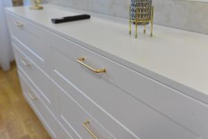 a white dresser with a chair sitting on top of it at Apartman Divine Lux Zlatibor in Zlatibor +24 photos