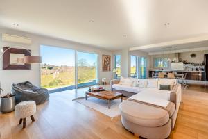 a living room with a couch and a table at VILLA ARCANGUES in Arcangues