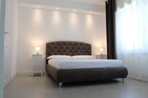 a bedroom with a large bed with two night stands at Villa Forte Salvi - Rooms in Peschiera del Garda