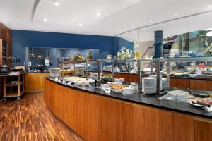 a buffet line in a restaurant with food on display at Falkensteiner Balance Resort Stegersbach - Adults only in Stegersbach