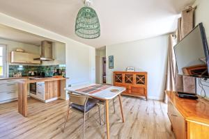 a kitchen with a table and chairs in a room at Beach House 1km de la plage in Audierne +12 photos