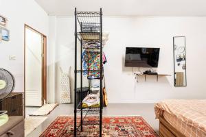 a black ladder in a room with a bedroom at Island Haven Phuket - Mai Khao in Ban Muang Mai (1)