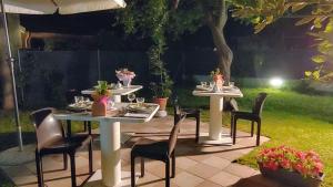 a table and chairs sitting on a patio at night at Villa Liberty B&B in Fano