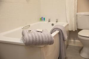 a bathroom with a bath tub and a towel at Sliabh Beagh Hotel in Monaghan